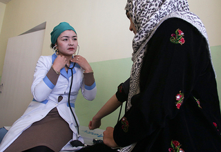 Mavluda Bobokalonova, director of the Rasht Reproductive Health Centre, provides a check-up and reproductive health counselling to a local woman. © UNFPA Tajikistan/Nozim Kalandarov