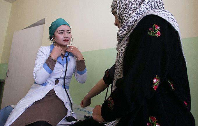 Mavluda Bobokalonova, director of the Rasht Reproductive Health Centre, provides a check-up and reproductive health counselling to a local woman. © UNFPA Tajikistan/Nozim Kalandarov